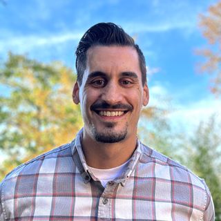 Me, standing outside on a beautiful day, smiling because I'm happy to see you!